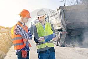 Two Surveyors Inspect Building Construction Site. Group of construction engineers on a building plot