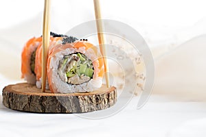 Two sushi rolls with shrimp, vegetables, flying fish roe closeup. Sushi roll japanese food in restaurant