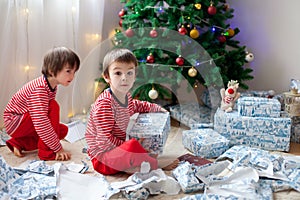 Two sweet boys, opening presents on Christmas day