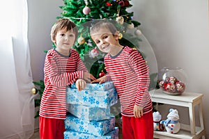 Two sweet children, boy brothers, opening presents