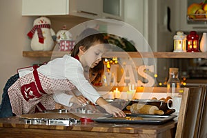 Two sweet children, boy brothers, preparing gingerbread cookies