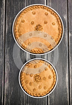Two sweet potato pies with edible decorations on top