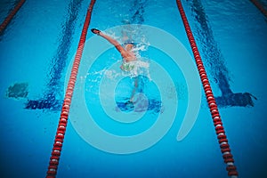 Two swimmers are practising swimming in the pool