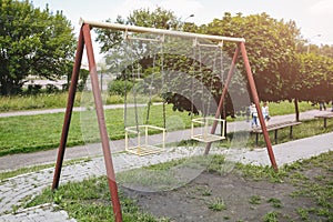 Two swings on children playground. Outdoors games for kids