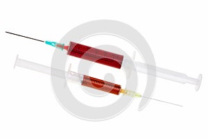 Two syringes with red liquid.