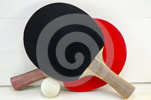 Two table tennis rackets and a ball