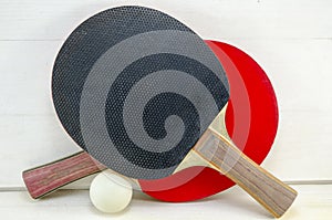 Two table tennis rackets and a ball