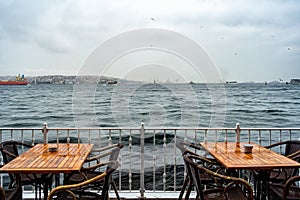 Two tables at an outdoor cafe on the seafront