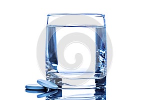 Two tablet near glass of water