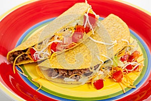 Two tacos on a red plate