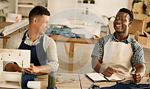 Two tailors talking and laughing. Cheerful businessmen collaborating and talking. Two design colleagues planning their