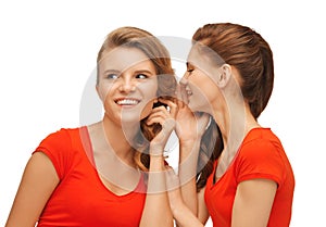 Two talking teenage girls in red t-shirts