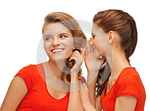 Two talking teenage girls in red t-shirts