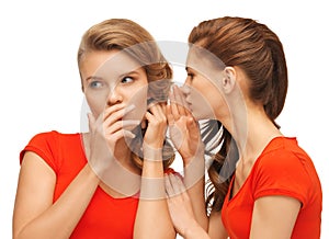 Two talking teenage girls in red t-shirts