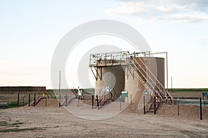 Two tanks used to store crude oil after it is pumped from the ground.