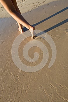 Two tanned women legs walking