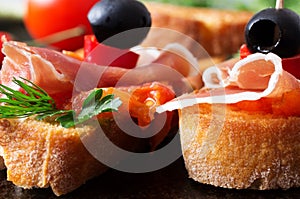 Two tapas with jamon with tomato