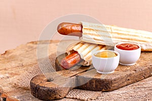 Two tasty grilled french hot dog with mustard and ketchup