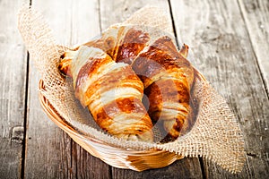 Two tasty oil croissants in basket