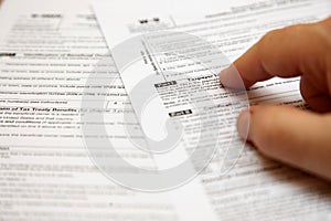 Two taxpayer forms with a hand photo