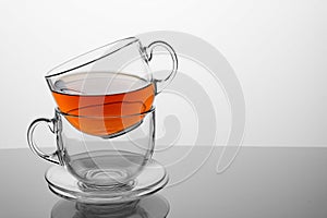 Two tea cups with tea on a white background.