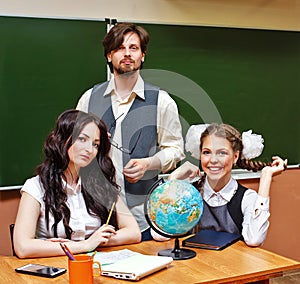 Two teachers and pupil geography lessons.