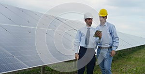 Two technical expert partners in solar photovoltaic panels, remote control performs routine operations to monitor the system using