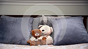 Two Teddy bears on the double luxuries bed. Copy space.