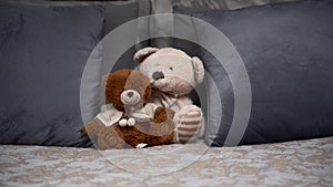 Two Teddy bears on the double luxuries bed. Copy space.