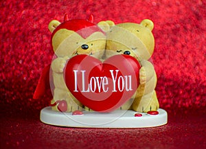 Two Teddy bears with heart I love you on red background