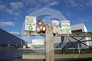 Two Teddy Bears Outside Recycling Plant Encouraging People To Recycle.