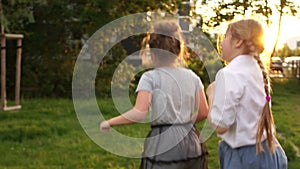 Two teen girls jumping for joy, summer holidays, happy childhood, back to school, outdoor portrait