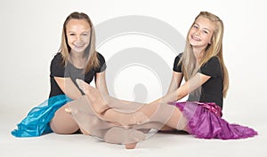 Two Teen Girls Modeling Fashion Clothes in Studio photo