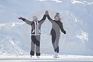 Two teen girls skating on ice rink after school
