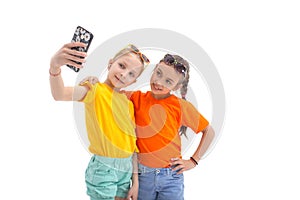 Two teen girls taking selfie with mobile phone