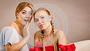 Two teen women gossiping