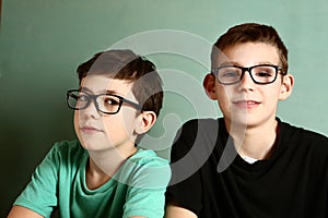 Two teenage boy in myopia glasses close up