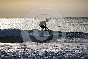 Two teenage boys are surfing before school in Japan