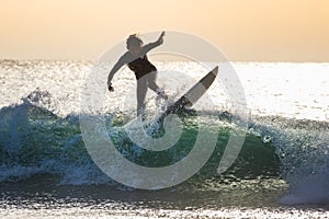 Two teenage boys are surfing before school in Japan