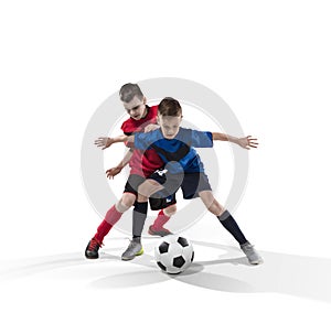 Two teenage fotball players struggling for the ball on white photo