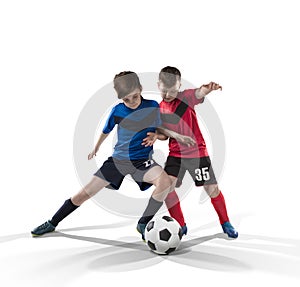 Two teenage fotball players struggling for the ball on white photo