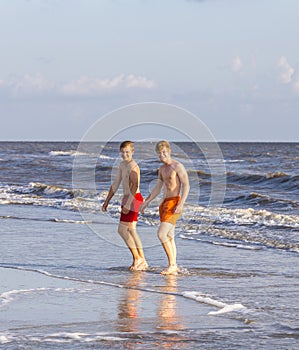 Two teenage friends and brothers at the beach