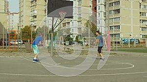 Two teenage friends practicing basketball skills