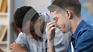 Two teenage friends watching sports match on tablet while favorite team losing