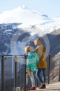 Two teenage girls on the background of the glacier Pasterze