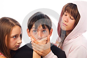 Two teenage girls harassing frightened boy