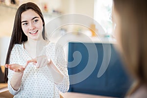 Two Teenage Girls Having Conversation Using Sign Language