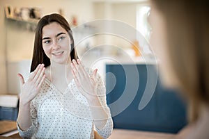 Two Teenage Girls Having Conversation Using Sign Language