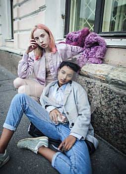 Two teenage girls infront of university building smiling, having fun, lifestyle real people concept