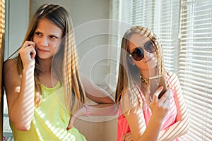 Two teenage girls looking in their gadgets